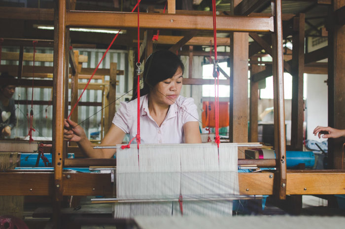 portrait of a lao woman at a silk factory in Laos taken by Milie Del