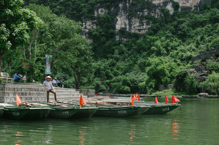 woman waiting for a boat tour at Tam Coc Vietnam taken by Milie Del