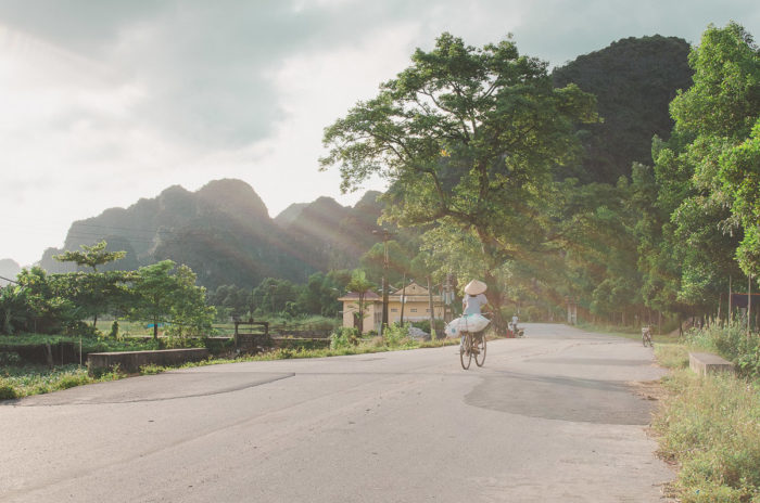 Girl riding a bike at sunset in ninh binh paradise Vietnam taken by Milie Del