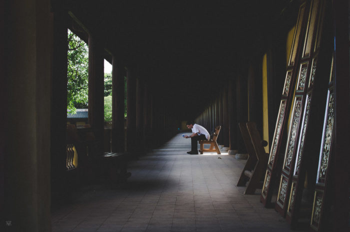 Man reading at hue imperial city Vietnam taken by Milie Del