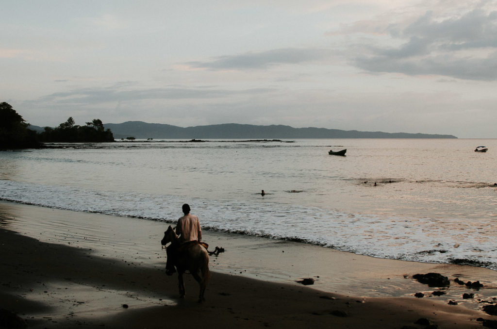 man horse walking down beach sunset Santa Catalina Panama