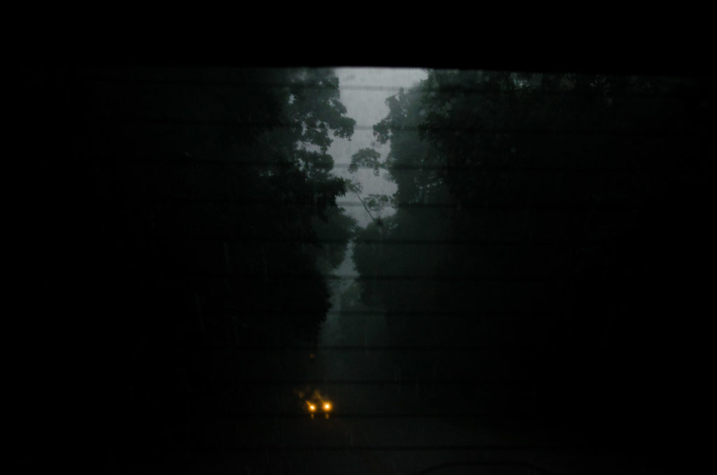 car headlights dark rainy tropical landscape Gamboa national park Panama