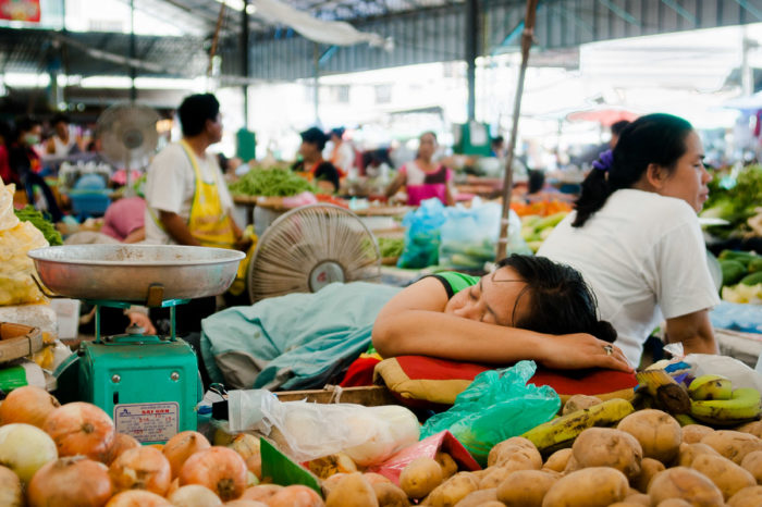 Woman sleeping at the market in Vientiane in Laos taken by Milie Del