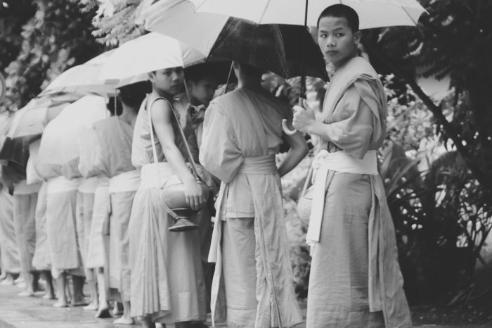 black and white photography of Early Morning Alms Giving to the Monks in Luang Prabang in Laos taken by Milie Del
