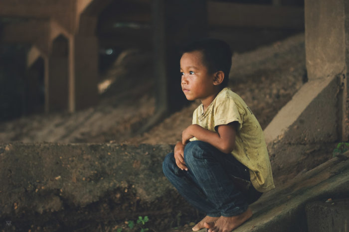 Little boy watching the sun in a abandoned factory on Don Det Island in Laos taken by Milie Del