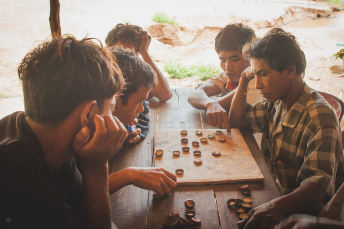 Men playing chess on Don Det island in Laos taken by Milie Del