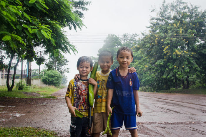 Portrait of Kids playing in a salt factory under the rain near Vientiane Laos taken by Milie Del
