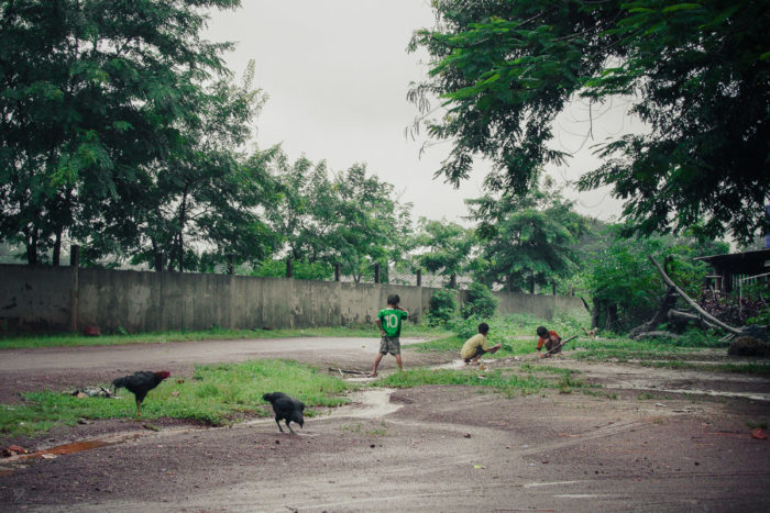 Landscape Kids playing in a salt factory under the rain near Vientiane Laos taken by Milie Del