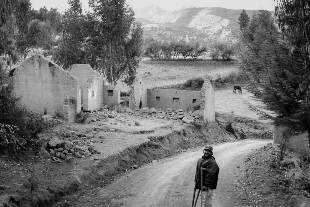 peruvian man with crutches in the andes mountains in peru photo taken by milie del
