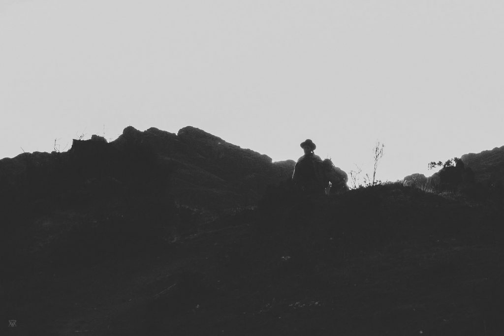 black and white photography of silhouette coming down of the mountains in the andes peru taken by milie del