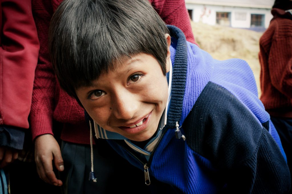 Portrait of a boy outside the school in the amary community in Peru taken by Milie Del