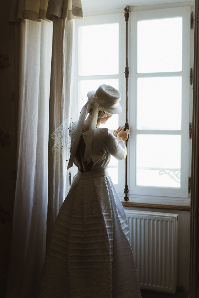 bride closing the window soft light