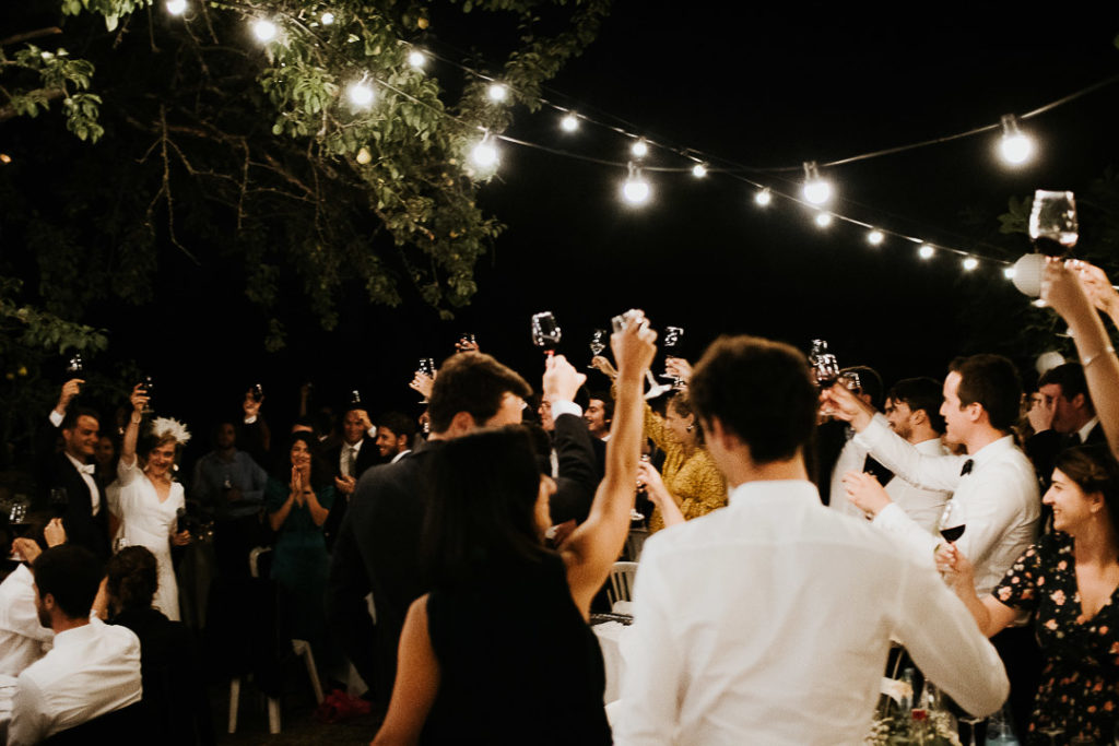 Raising glasses and Wedding couple speech under the fig trees