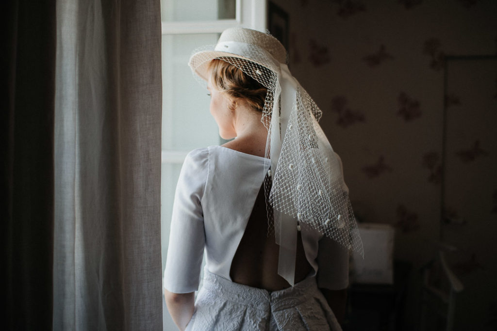 bride closing the window soft light