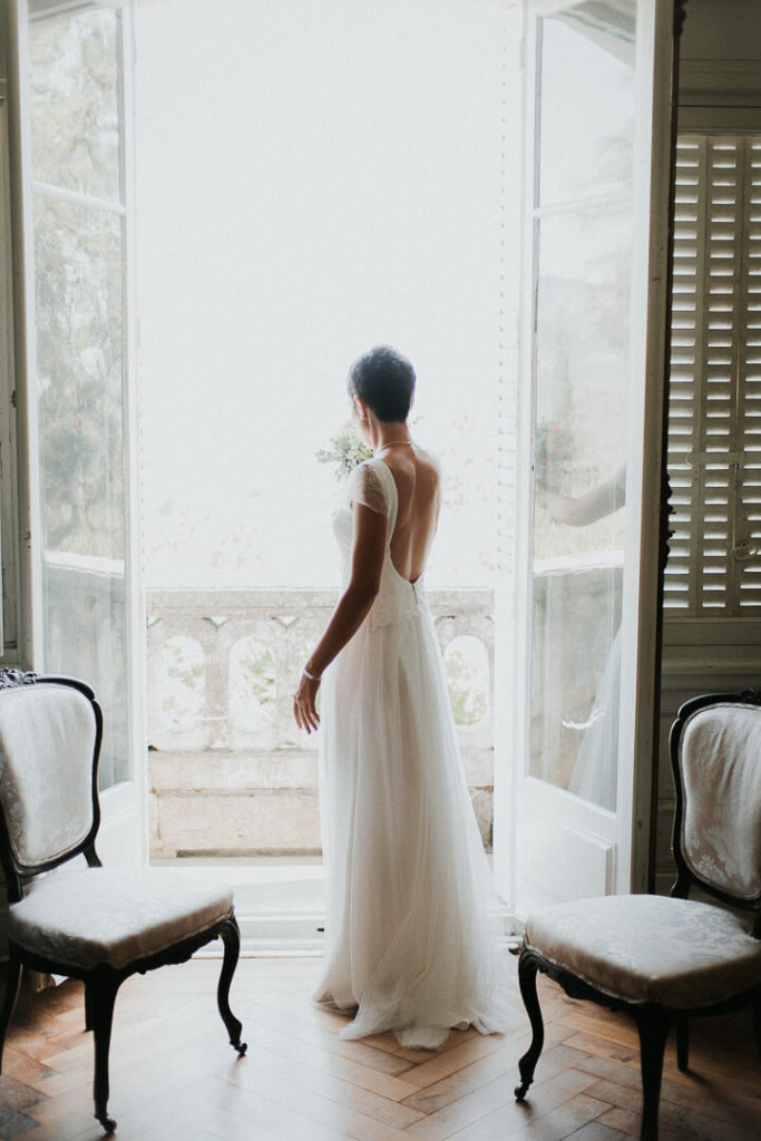 bride bridal prep modern wedding in the window light