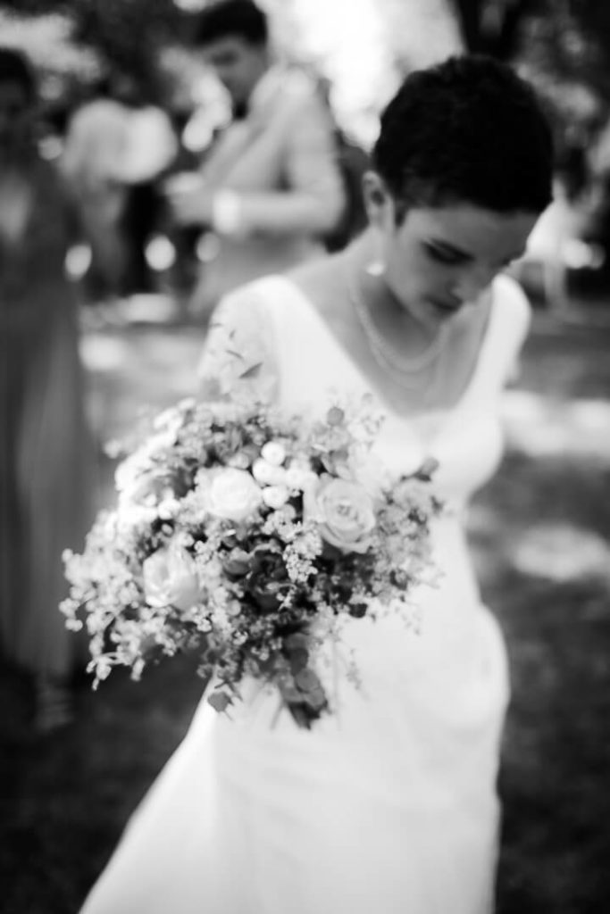 Black and white bride walking down the aisle with her bouquet