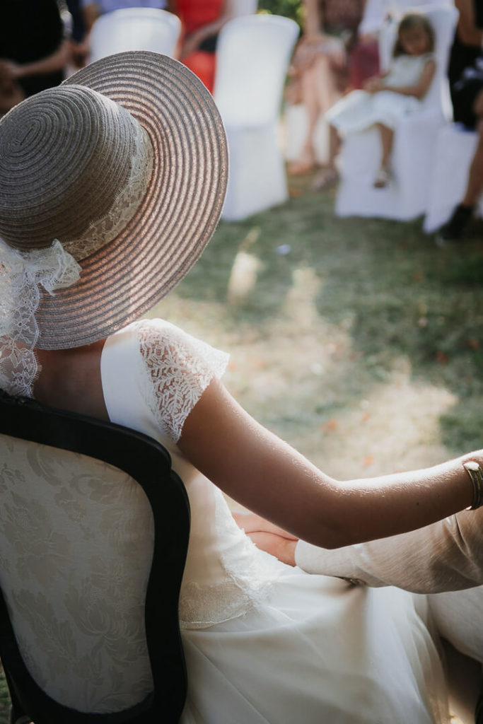 Bride's hat during the outdoor ceremony