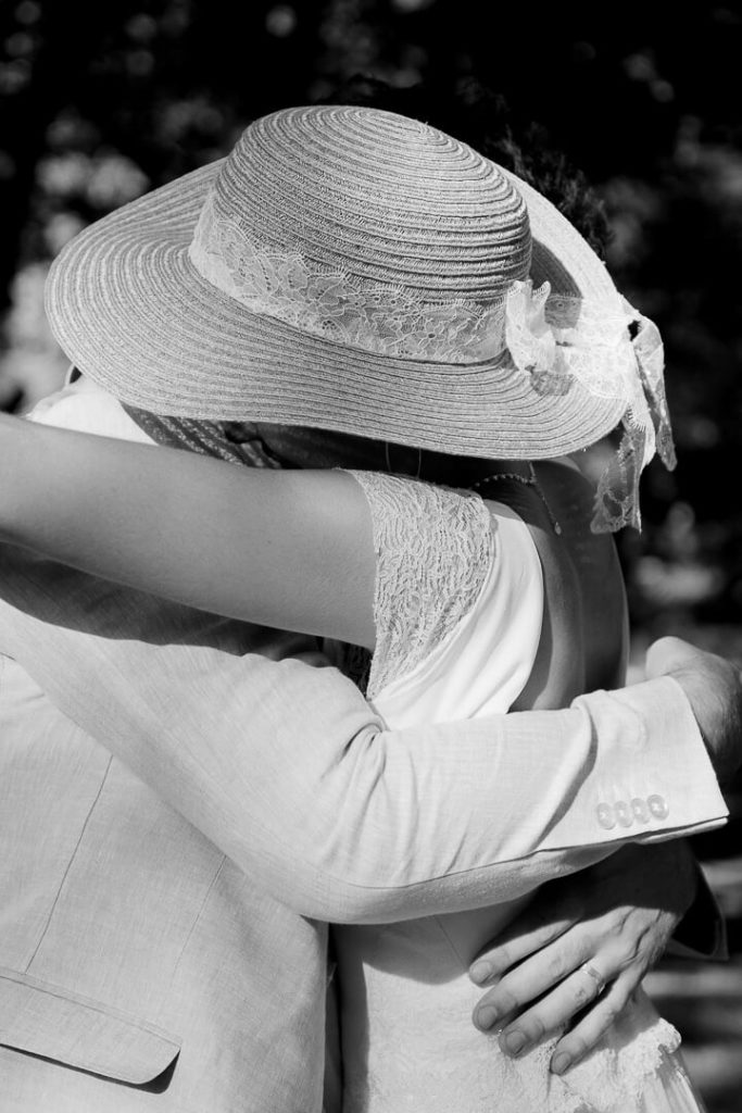 Newly wed Bride and groom kissing during the outdoor ceremony