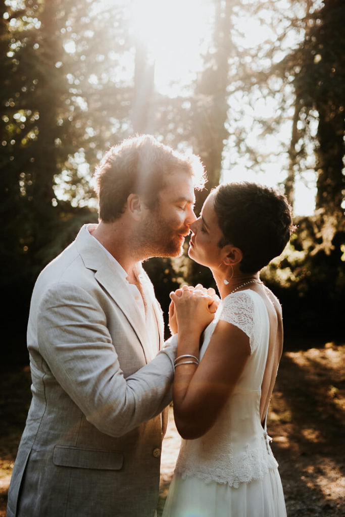Newly wed Bride and groom kissing at sunset