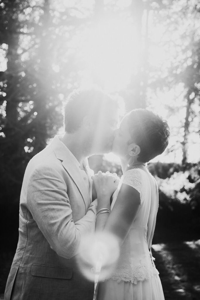 Newly wed Bride and groom kissing at sunset