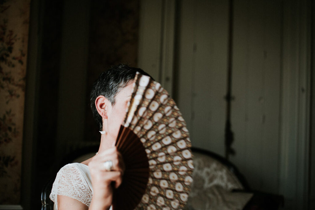 bride hiding behing a chinese range bridal prep