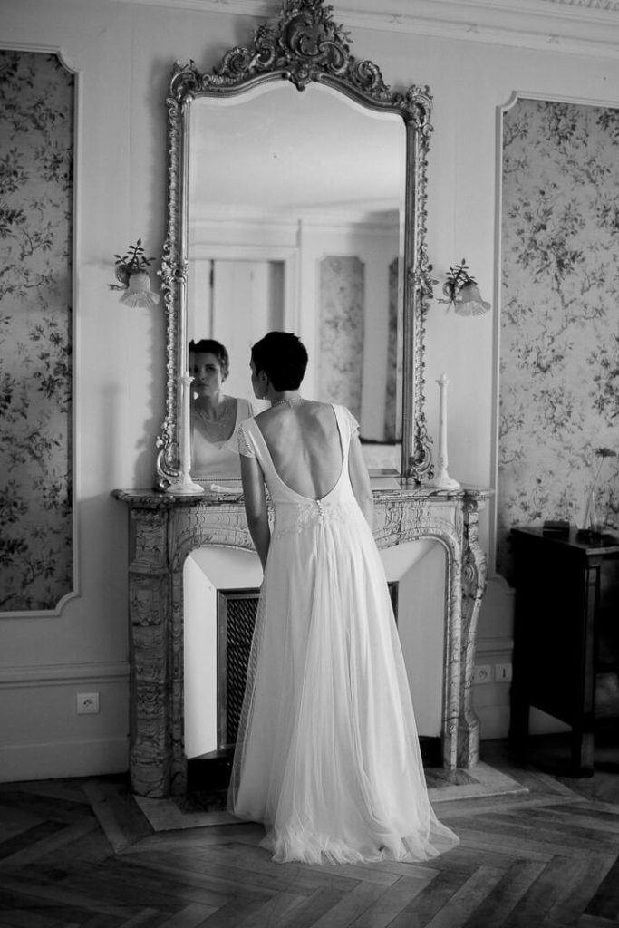 bride looking in the mirror bridal prep Louis XVI bedroom
