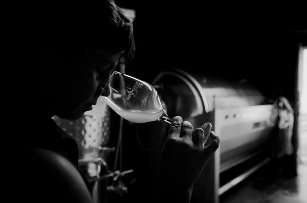 Amelie Czerwenka tatsing wine in the wine cellar