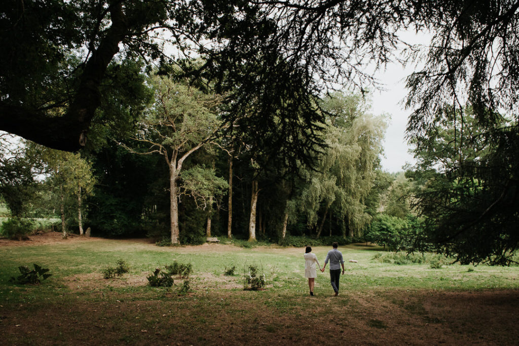 french australian couple walking in the forest burgundy