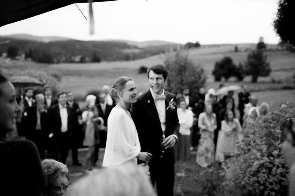 wedding couple with umbrella under the rain