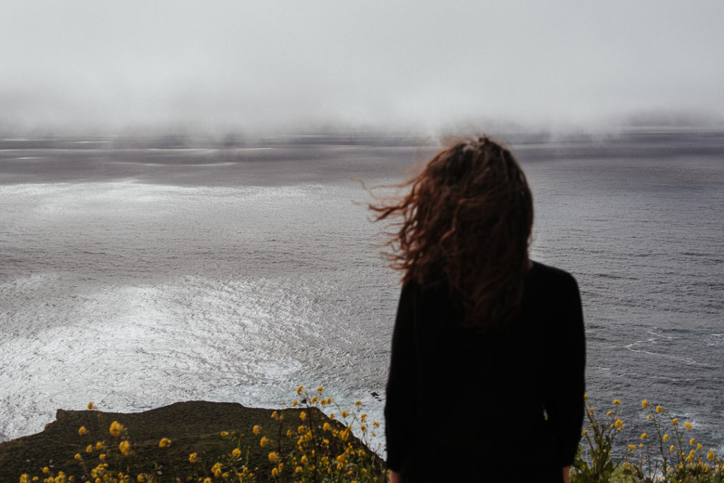 girl watching the ocean in Big Sur pfeifer state park california