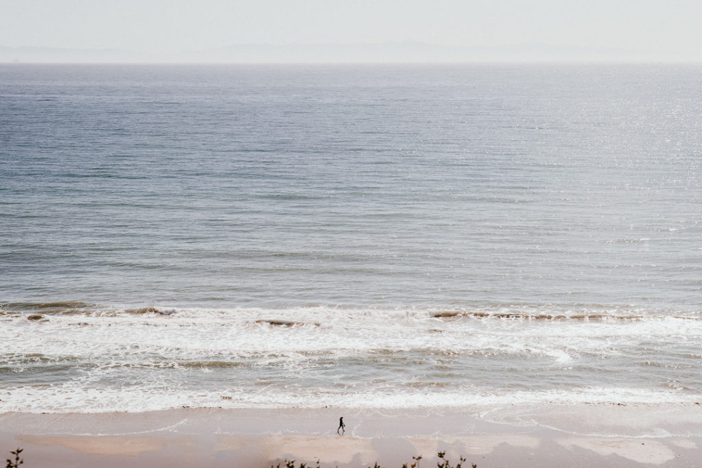 man walking on the beach Malibu California