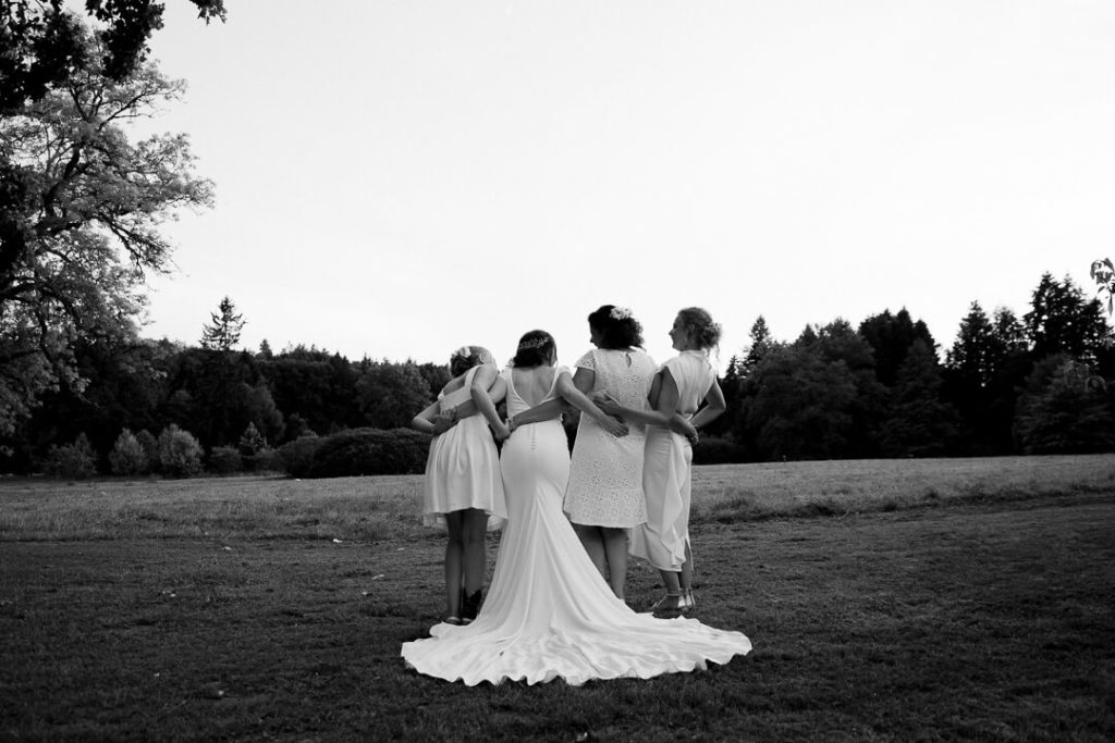 4 sister in white dresses laughing