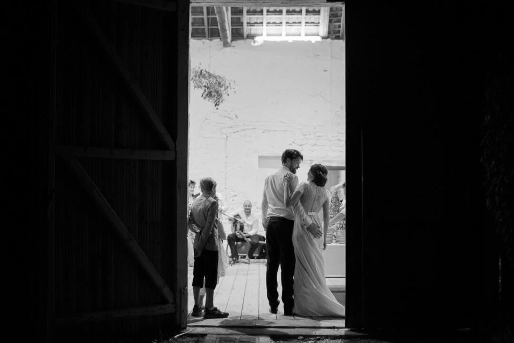 couple holding each other old farm wedding