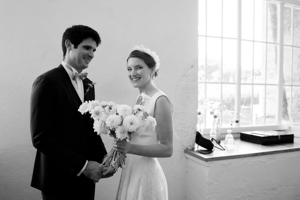 Bride and groom and dahlia flowers Château de Sully
