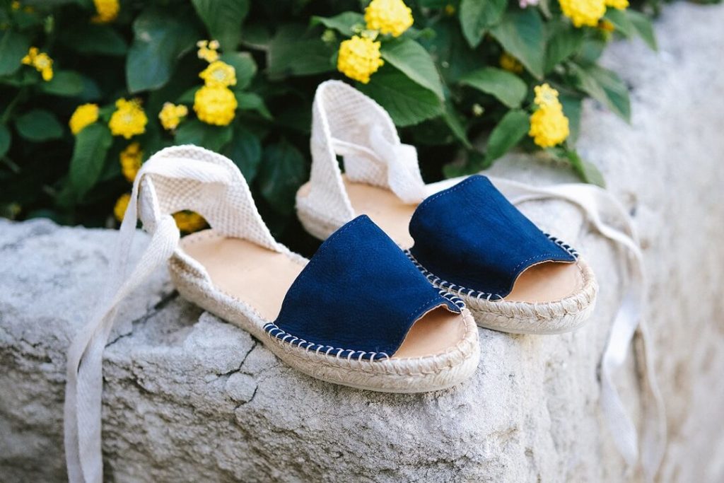 Blue shoes and yellow flowers for summer vibes in South of france by Milie Del Editorial photographer