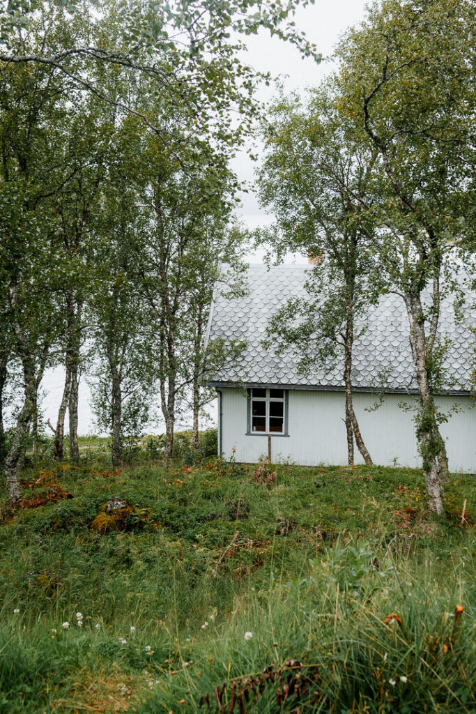 little white house near the lake on the road to Tromso